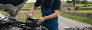 A technician's using a battery tester to check a vehicle's health for a mobile car battery replacement Manchester call-out.