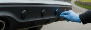 Parking sensors fitted in Manchester showing a close-up of a car's rear bumper with professionally integrated proximity sensors installed for a seamless finish.