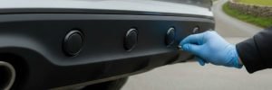 Parking sensors fitted in Manchester showing a close-up of a car's rear bumper with professionally integrated proximity sensors installed for a seamless finish.